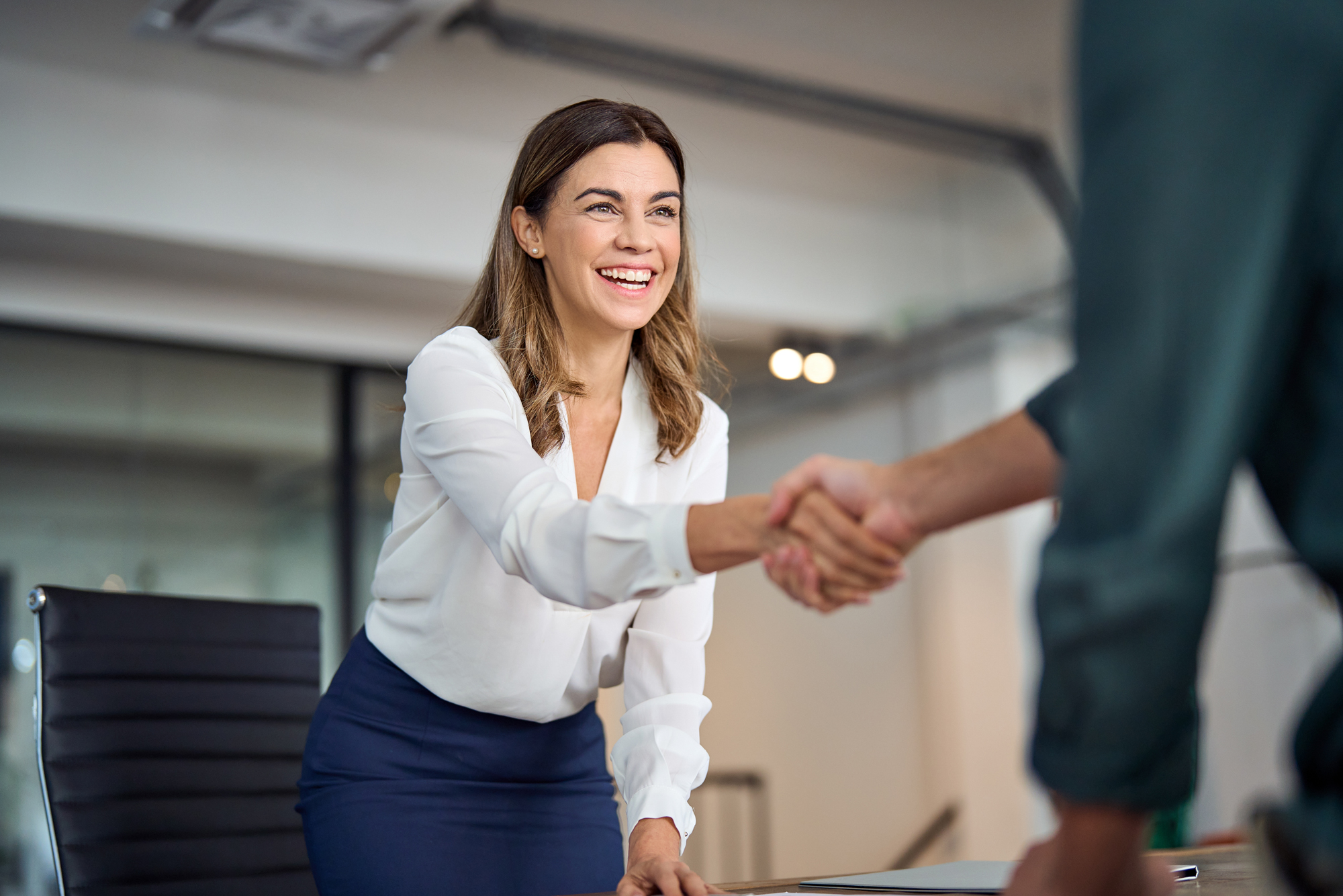 Photo of a woman shaking hand with a man.